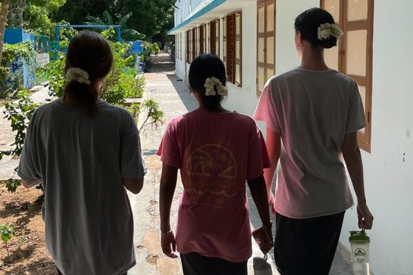 Three volunteers on a walkway at ASSA